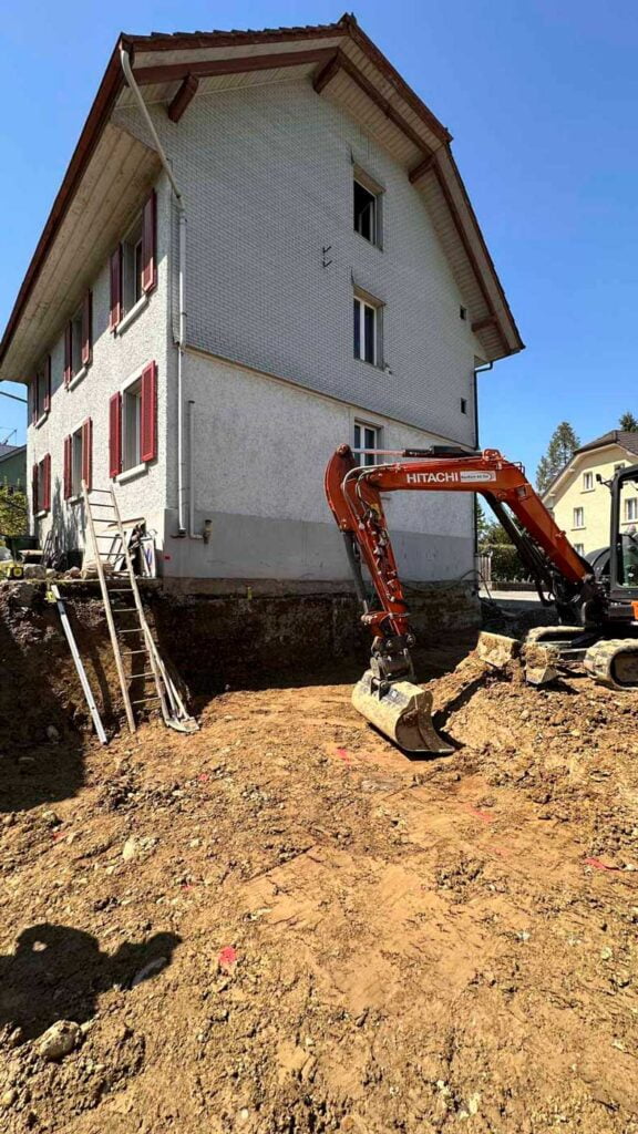 Aushubarbeiten, Bagger und Kelleraussenwand